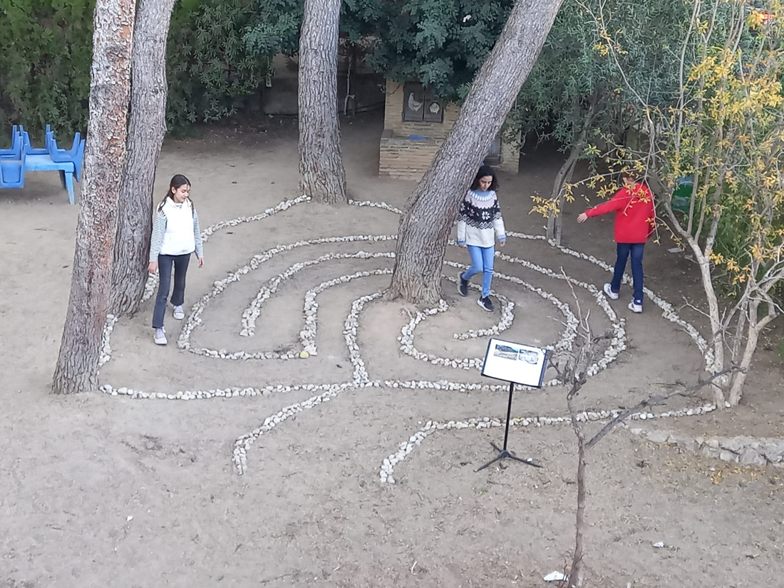 Alumnas paseando por el laberinto Land-Art elaborado en el jardín de Educación Infantil, dentro del proyecto Abuelísimos - Alumnos de 1º ESO del Centro Educativo Gençana